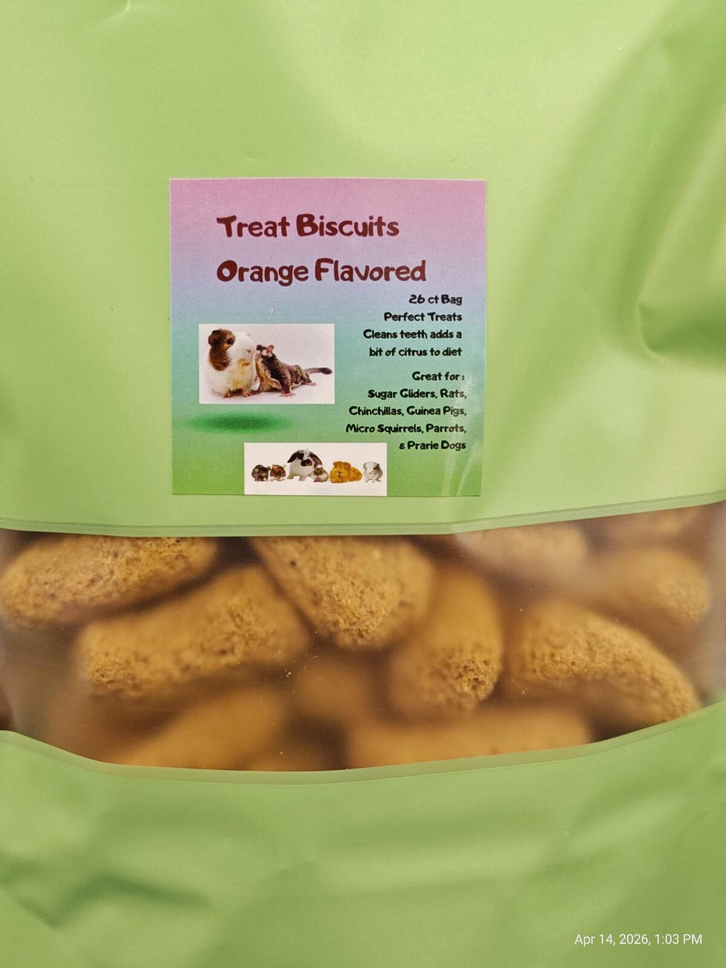Green bag of orange-flavored treat biscuits with a label on top.