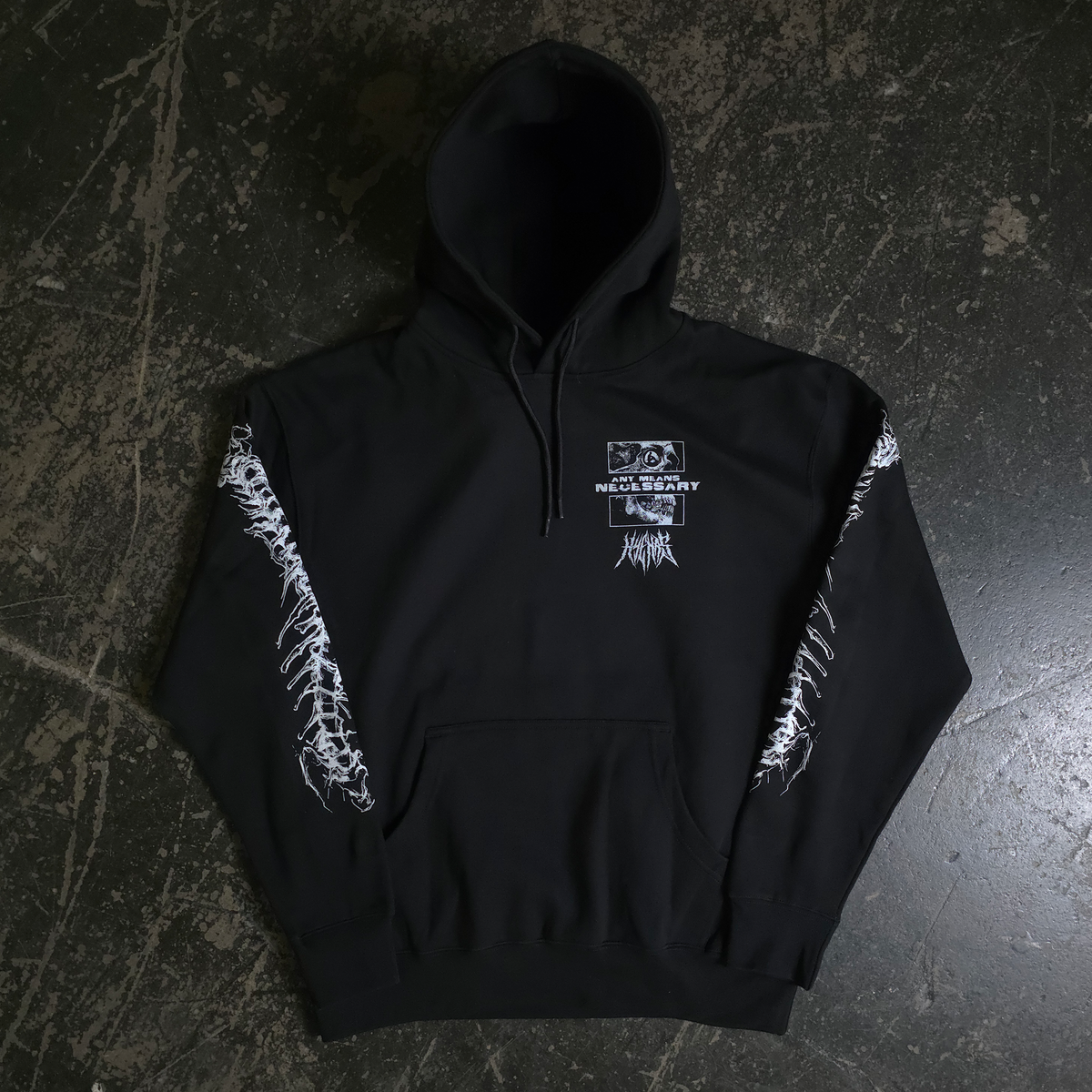 Black hoodie with white designs on a dark textured surface