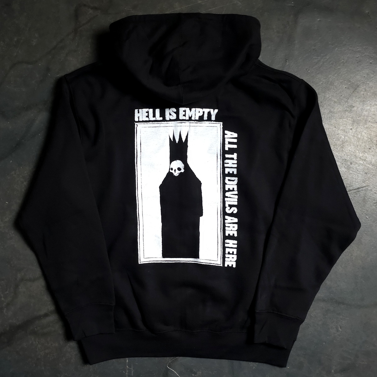 Black hoodie with graphic design and text on a dark surface
