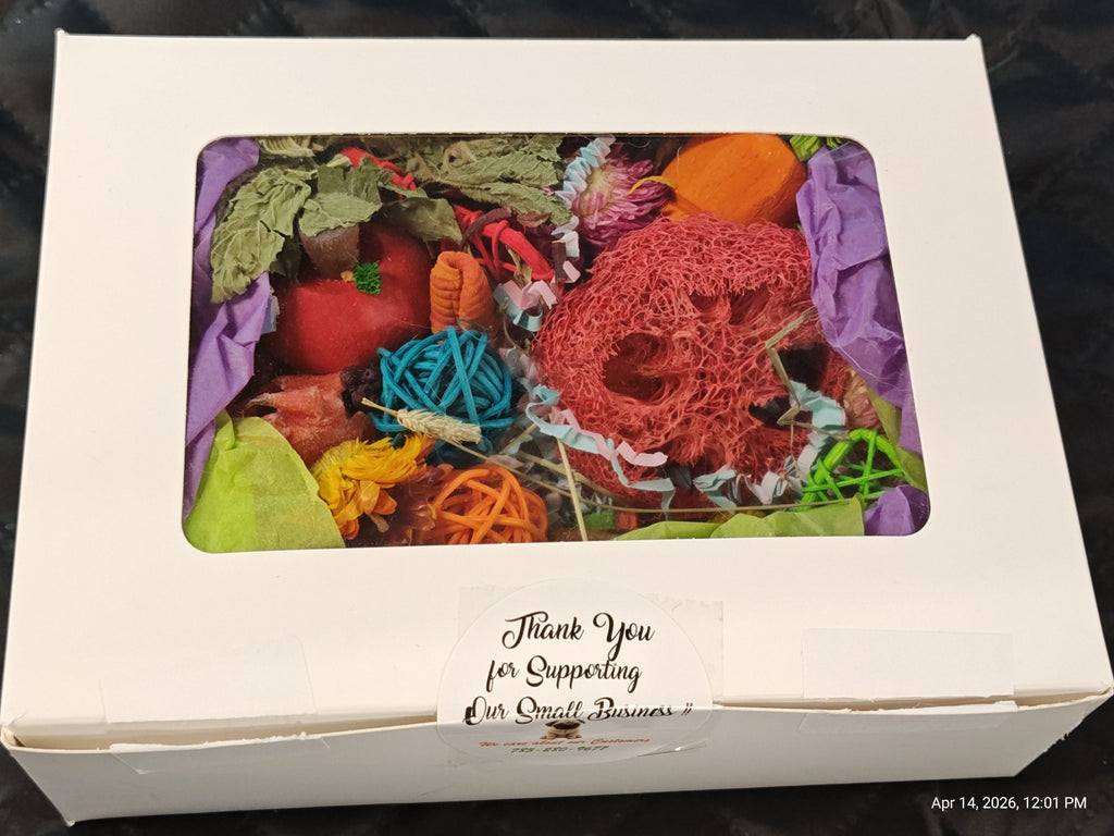 A white gift box with a clear window showing a colorful assortment of handmade yarn balls and greenery inside, with a handwritten thank you note on the front.