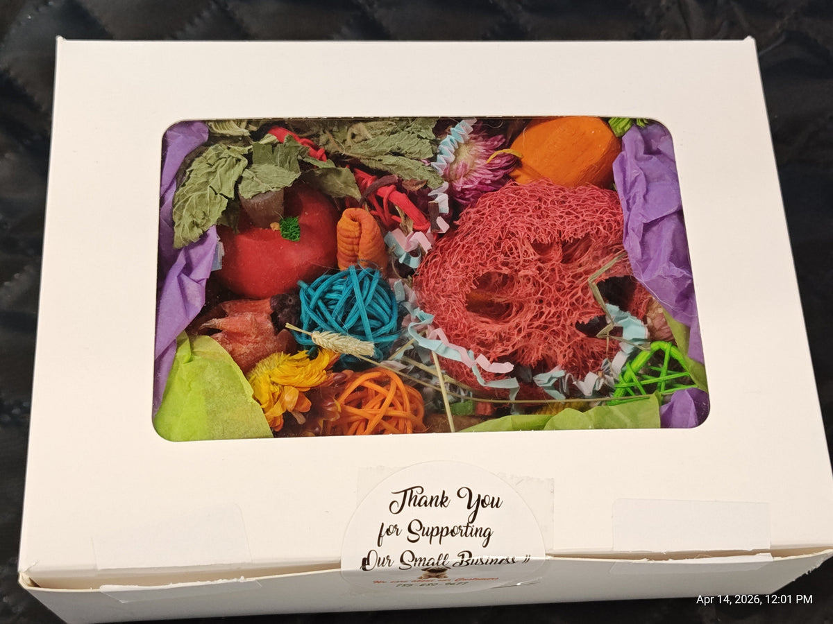 A white cardboard gift box with a clear window showing a colorful handmade craft or gift assortment inside, including purple tissue paper and multicolored yarn-like balls. A handwritten note on the front says 'Thank You for Supporting Our Small Business'.