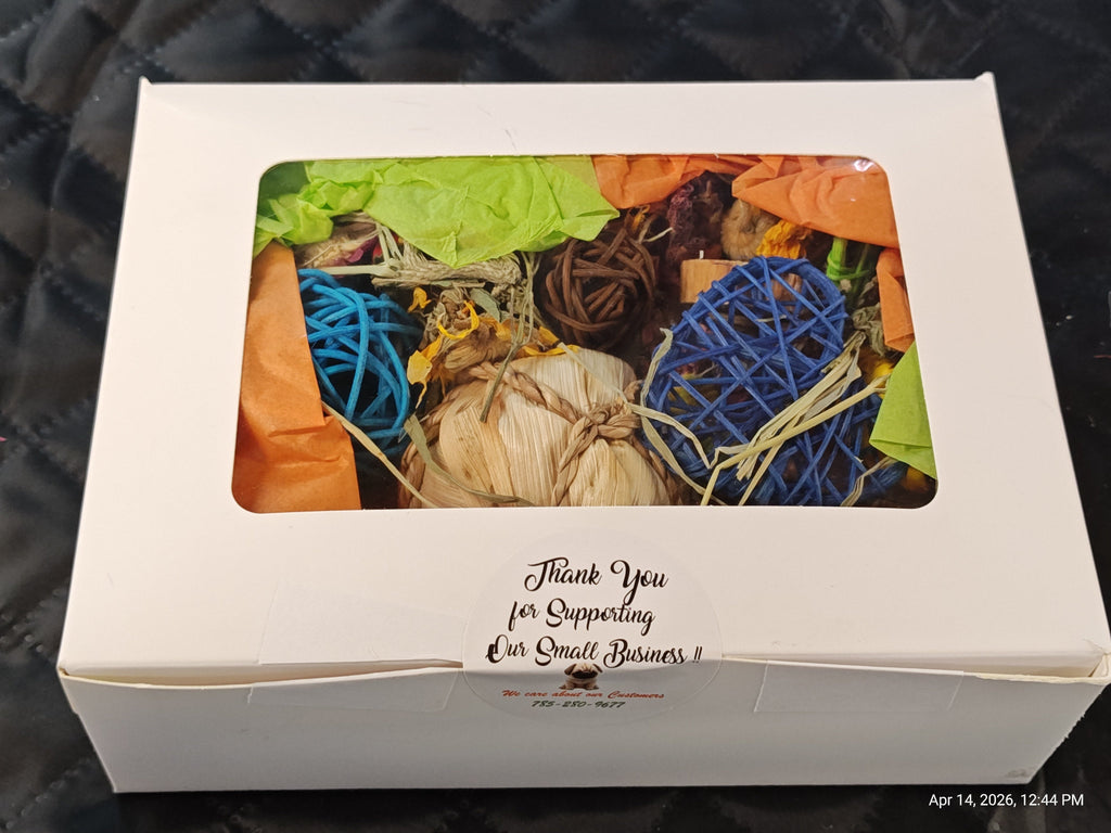 A white cardboard gift box with a clear window showing dried botanicals, orange tissue paper, and colorful yarn balls in blue, brown, and beige. The front of the box has printed text reading 'Thank You for Supporting Our Small Business!'.