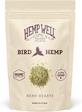 A stand-up pouch of Hemp Well Bird Hemp, labeled 'Hemp Hearts,' on a plain white background. The cream-colored bag features dark purple text and a small pile of greenish-yellow hemp hearts shown near the center.
