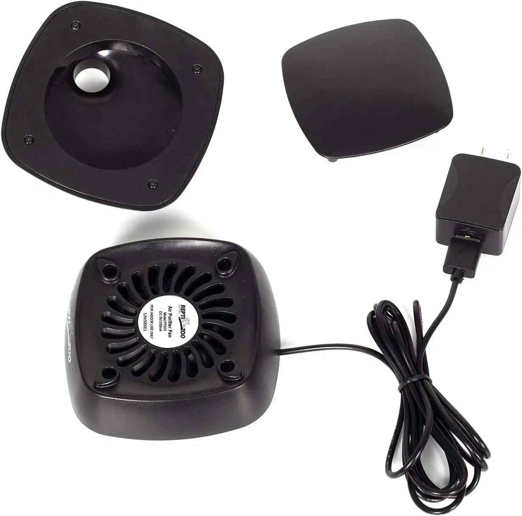 Black reptile terrarium fan, a matching cover, a square mounting plate, and a black power adapter on a white background.