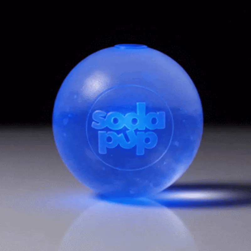 Blue ball with 'soda pup' branding on a reflective surface.