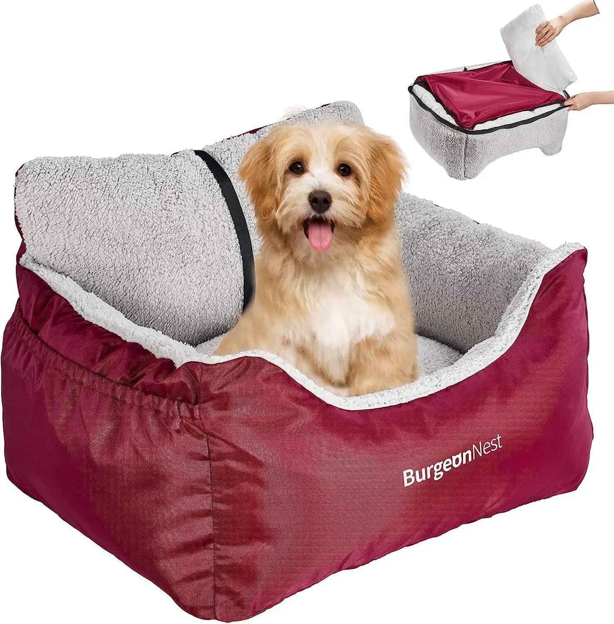 A small fluffy dog sits in a burgundy and gray pet bed on a white background, with a hand shown opening the top lid in a small inset at the upper right. The bed has a plush gray fleece interior and a burgundy exterior with white 'BurgeonNest' branding.