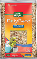 Wild Harvest Daily Blend Parakeet Canary & Finch bird seed in a 10 lb bag, featuring a red, orange, and yellow label with pictures of colorful parakeets.