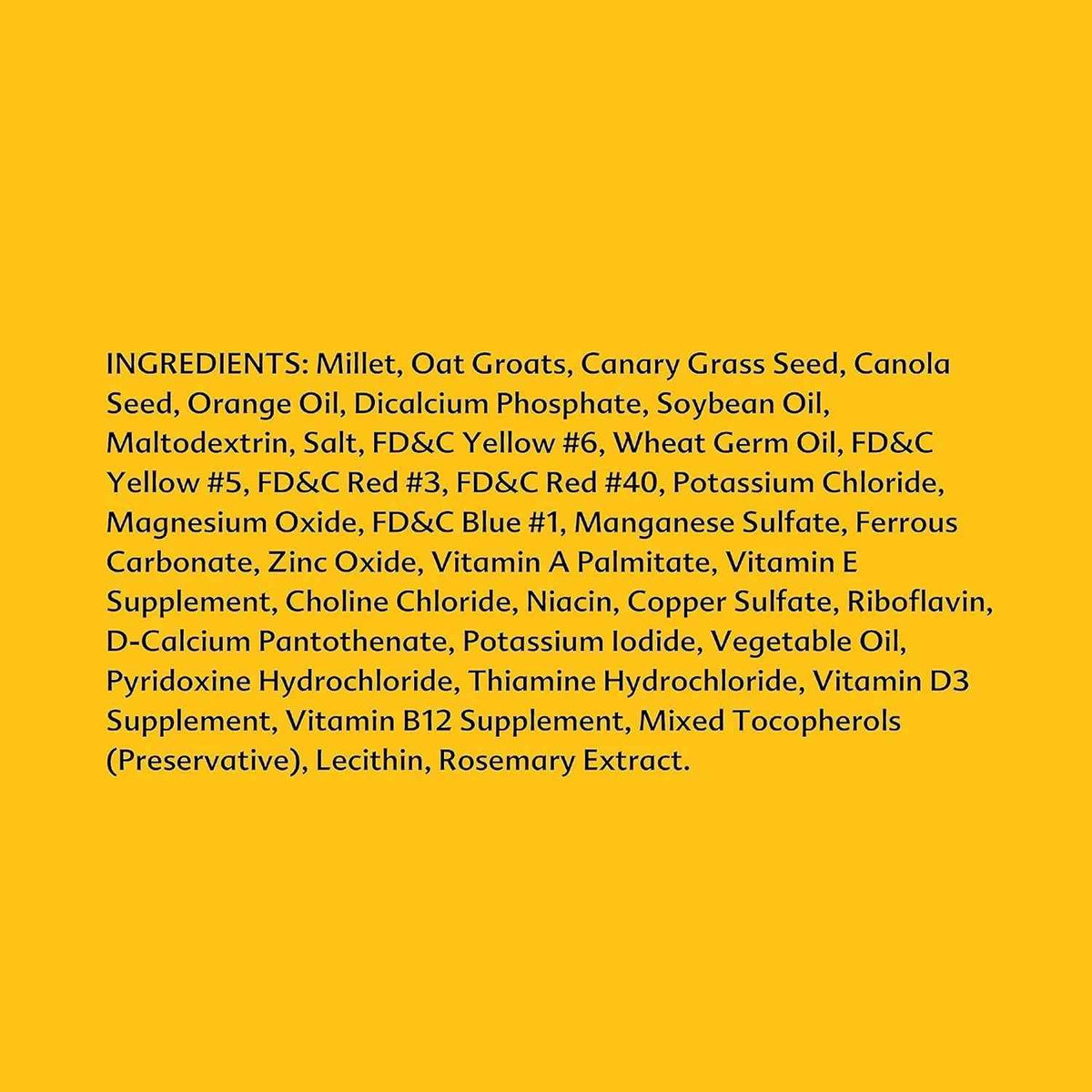 A solid yellow square background with black text listing the ingredients of a supplement blend, including millet, oat groats, canary grass seed, canola seed, orange oil, and various vitamins and minerals.
