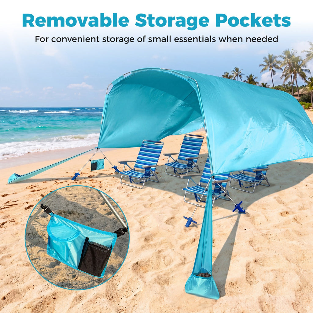 Blue beach tent with removable storage pockets on a sandy beach with ocean view