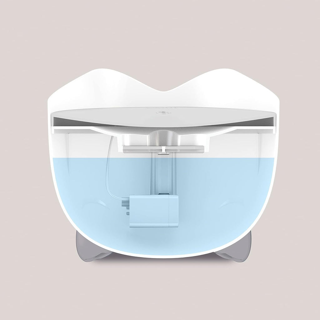 White and blue cat water fountain on a beige background