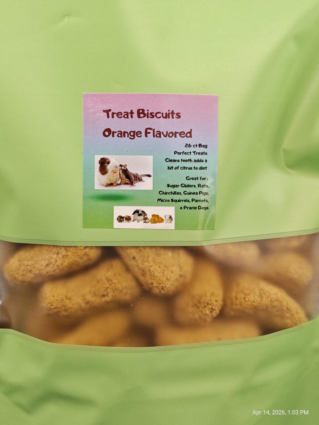 Green bag of orange-flavored treat biscuits for dogs with a label on a white background
