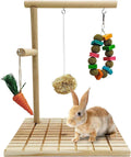 Pet play stand with hanging toys and a rabbit on a white background