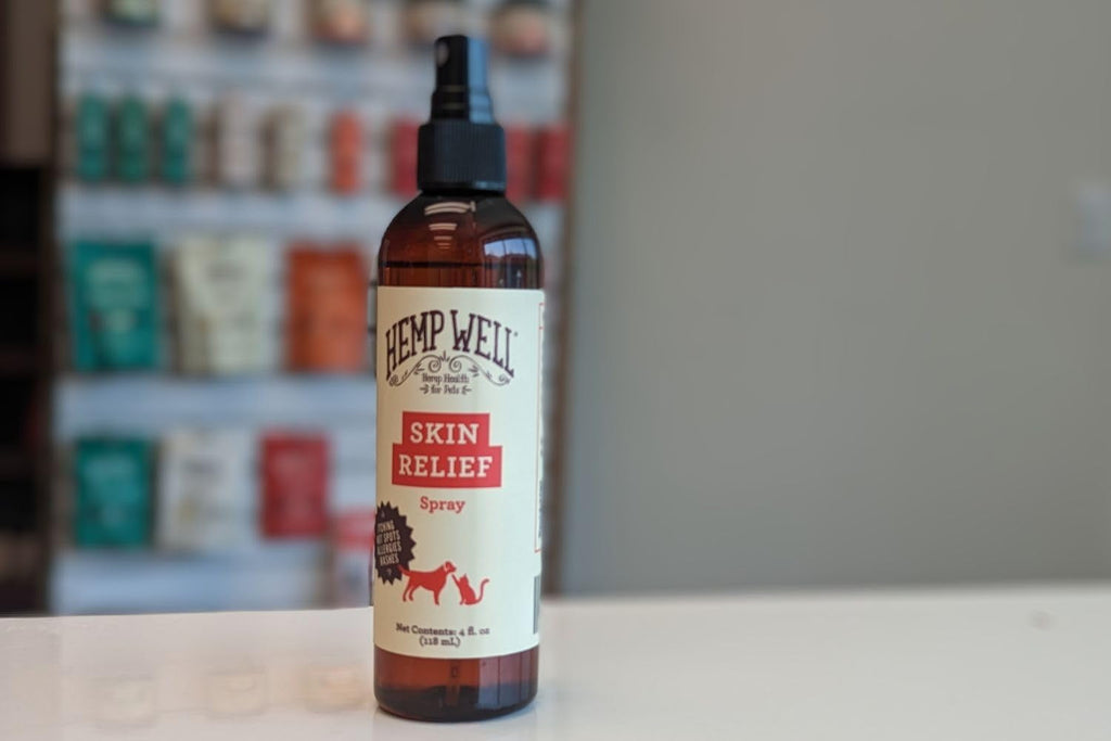 Bottle of Hemp Well Skin Relief Spray on a counter with a blurred background