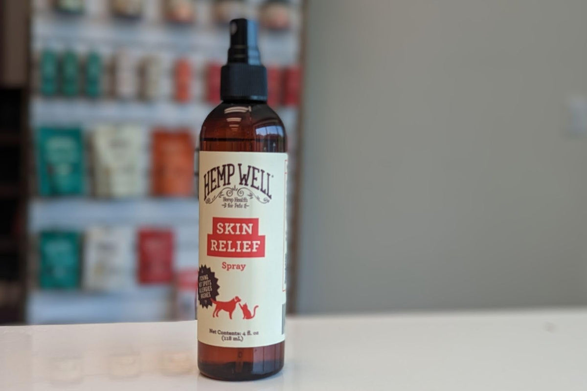 Bottle of Hemp Well Skin Relief Spray on a counter with a blurred background