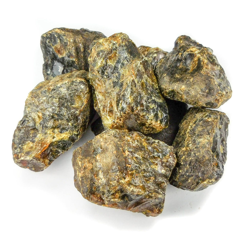 Assorted chunky black amber pieces showing irregular shapes and textured brown and gold surfaces