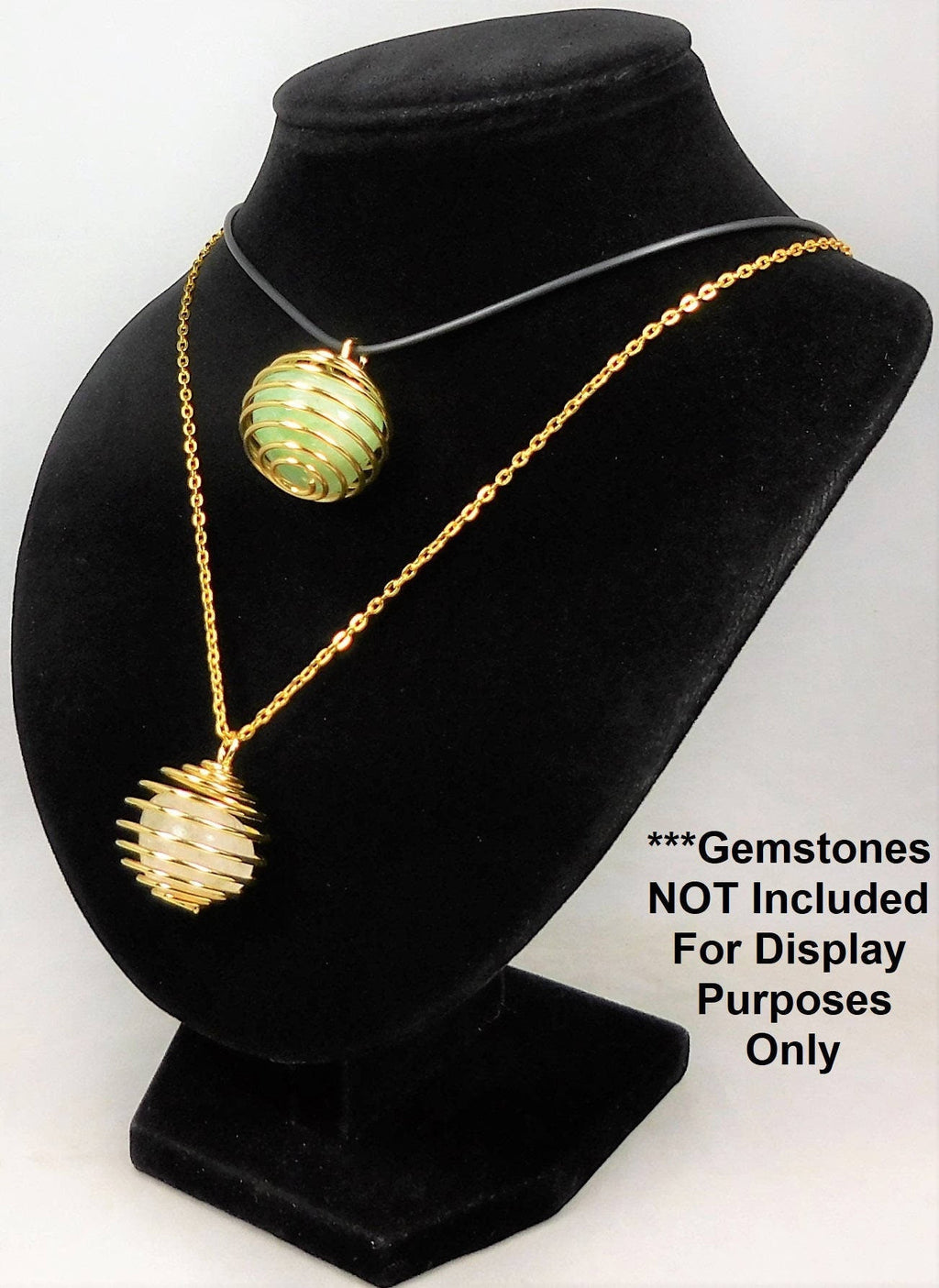 Two gold-finish crystal cage pendants displayed as necklaces on a black bust, with gemstones not included notice