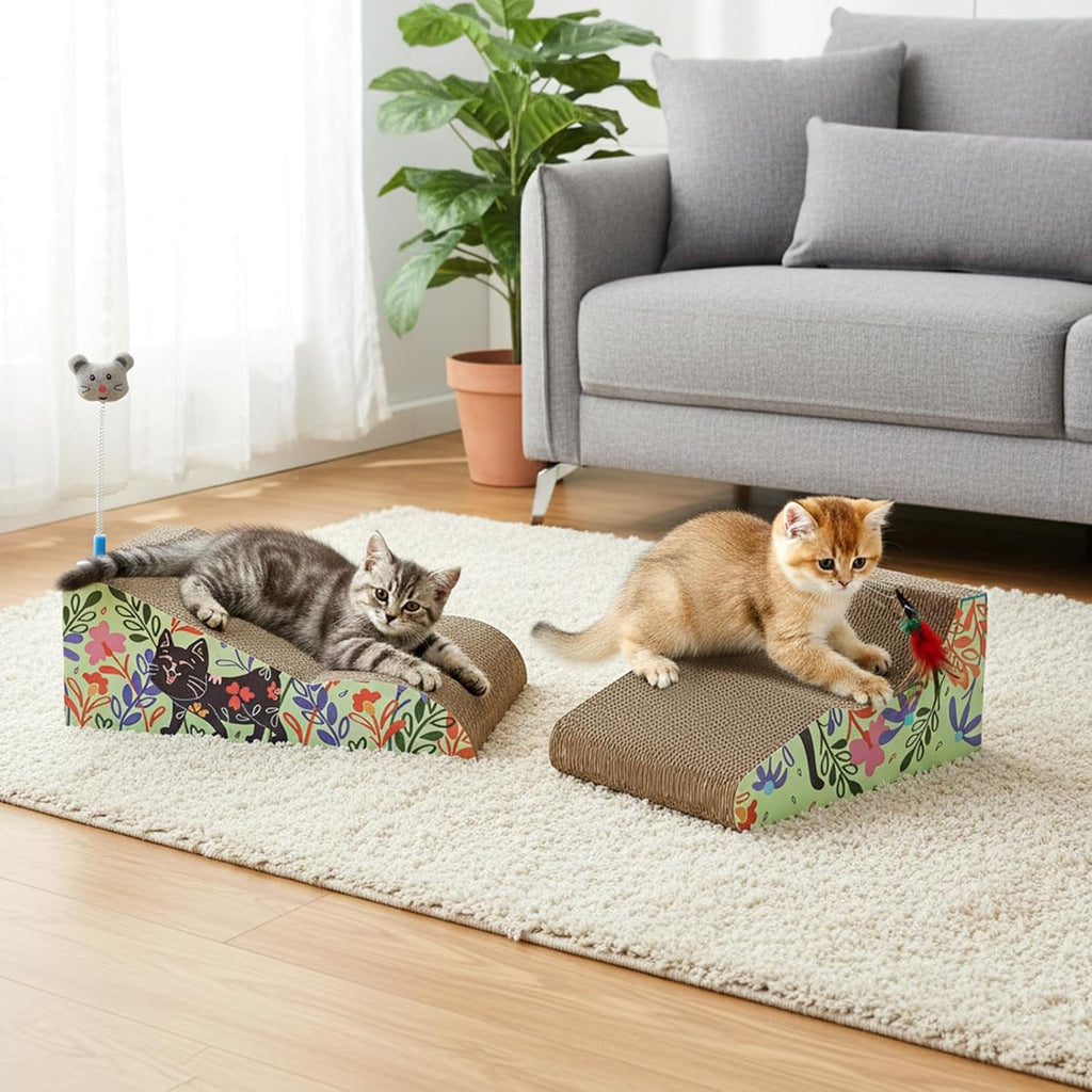 Two cats play with two cat scratchers in a bright living room. One cat is lying on a rectangular scratcher with a floral print, and the other is standing on a wedge-shaped scratcher.