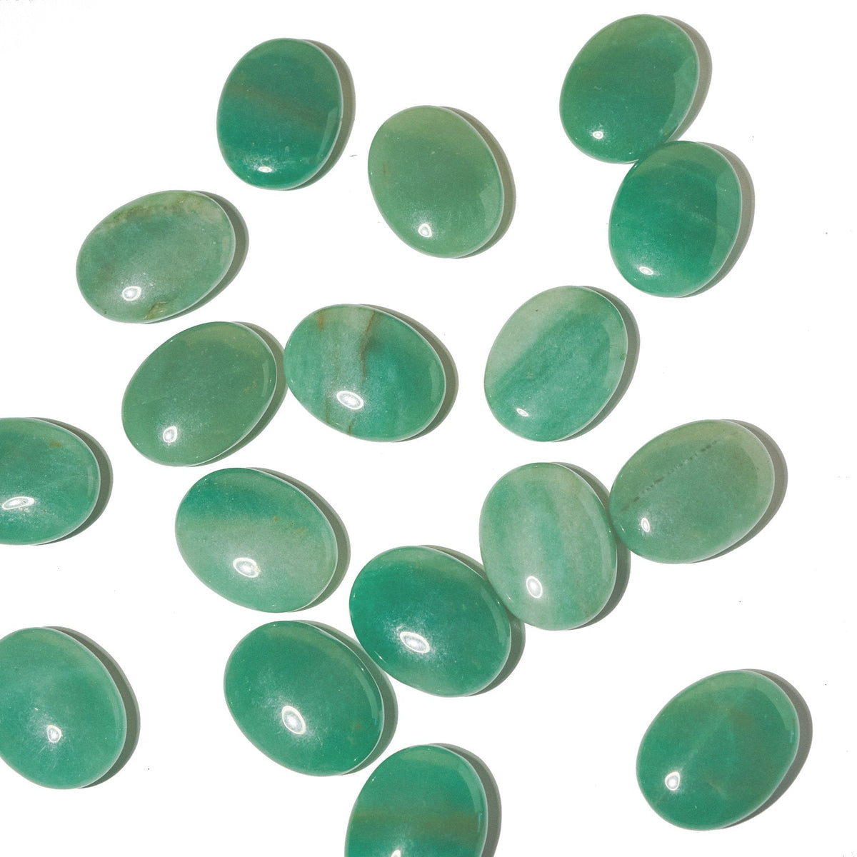 Assorted polished green aventurine palm stones showing varied green tones and rounded oval shapes on white.
