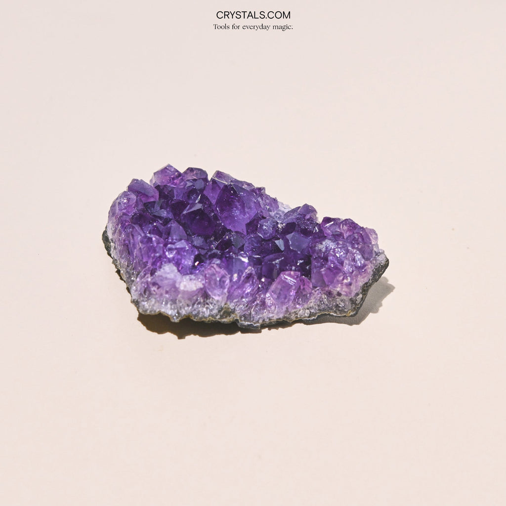 Close-up of an irregular amethyst cluster with large purple points and pale edges.
