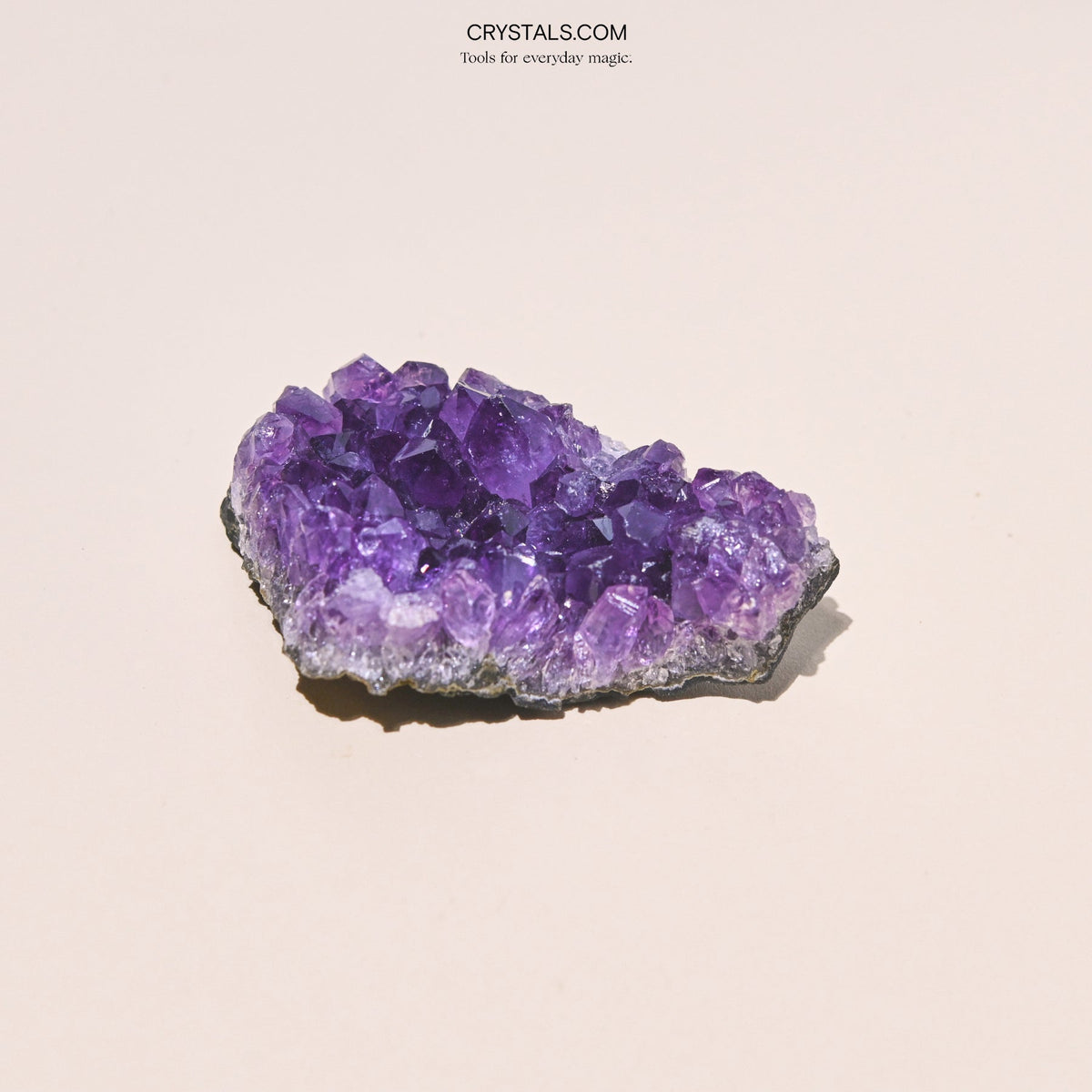 Close-up of an irregular amethyst cluster with large purple points and pale edges.
