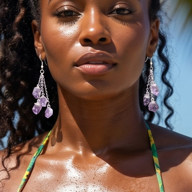 Model wearing long purple amethyst crystal dangle earrings with silver-colored chains outdoors.