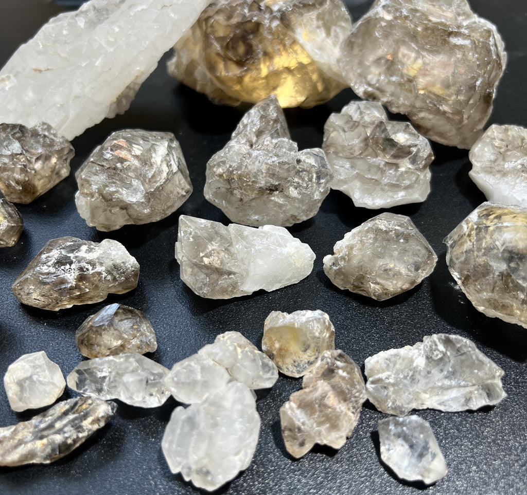 Close-up of small and large rough quartz clusters showing translucent faces, milky areas and irregular contours