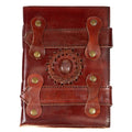 Brown leather journal with a rose quartz centerpiece, braided leather ring, layered straps and metal rivets