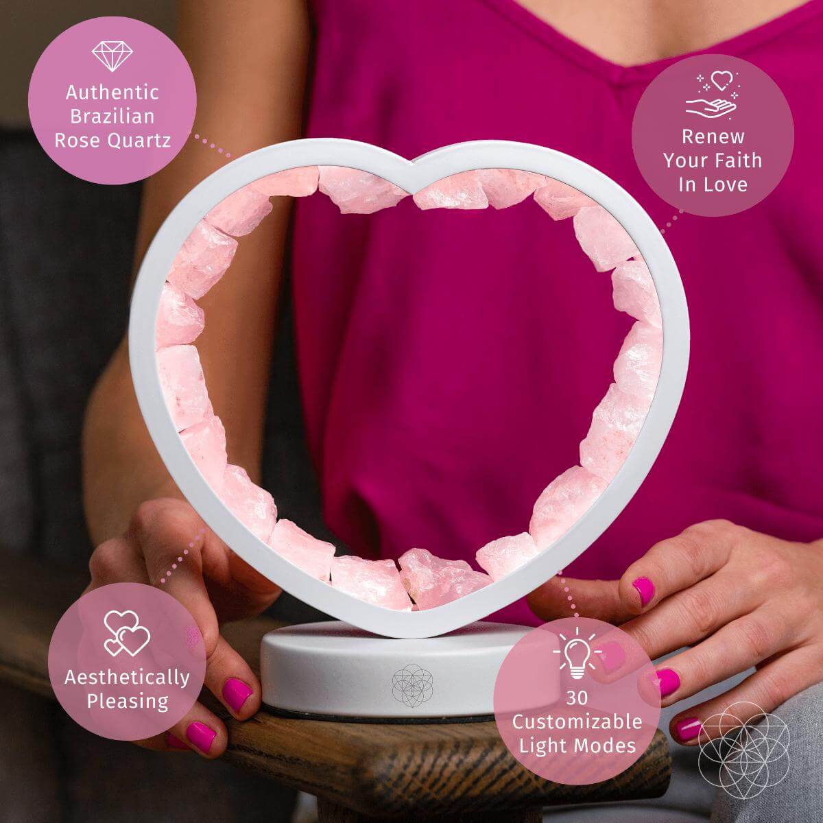 Person displaying a rose quartz heart lamp with callouts for Brazilian rose quartz and 30 customizable light modes.
