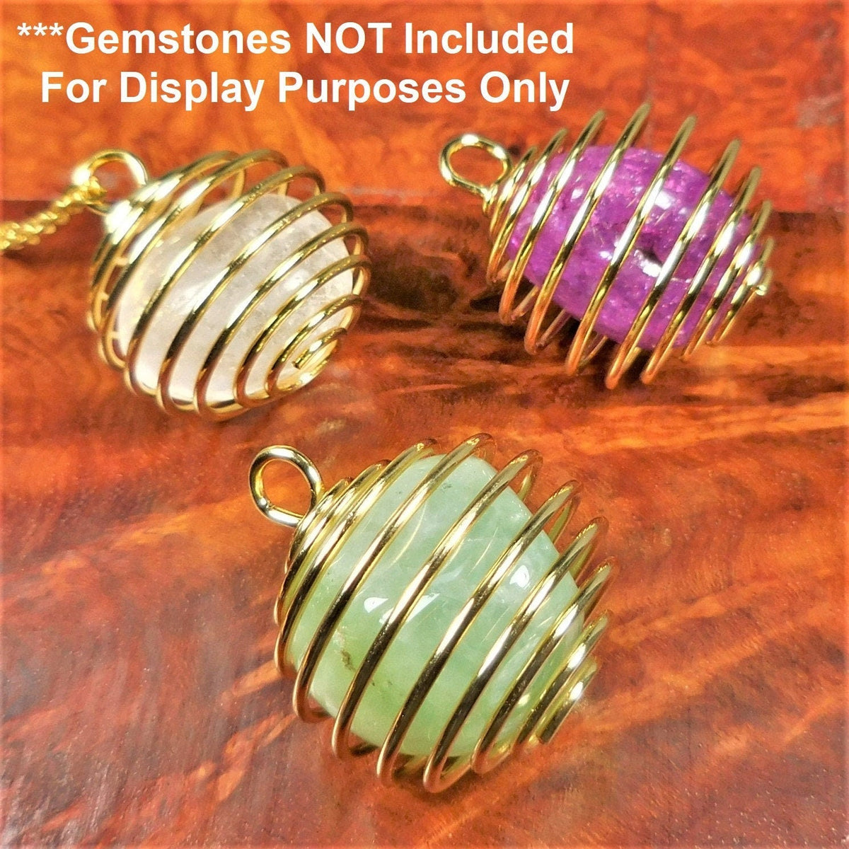 Three gold-finish spiral cage pendants holding white, purple and pale green stones for display; gemstones not included