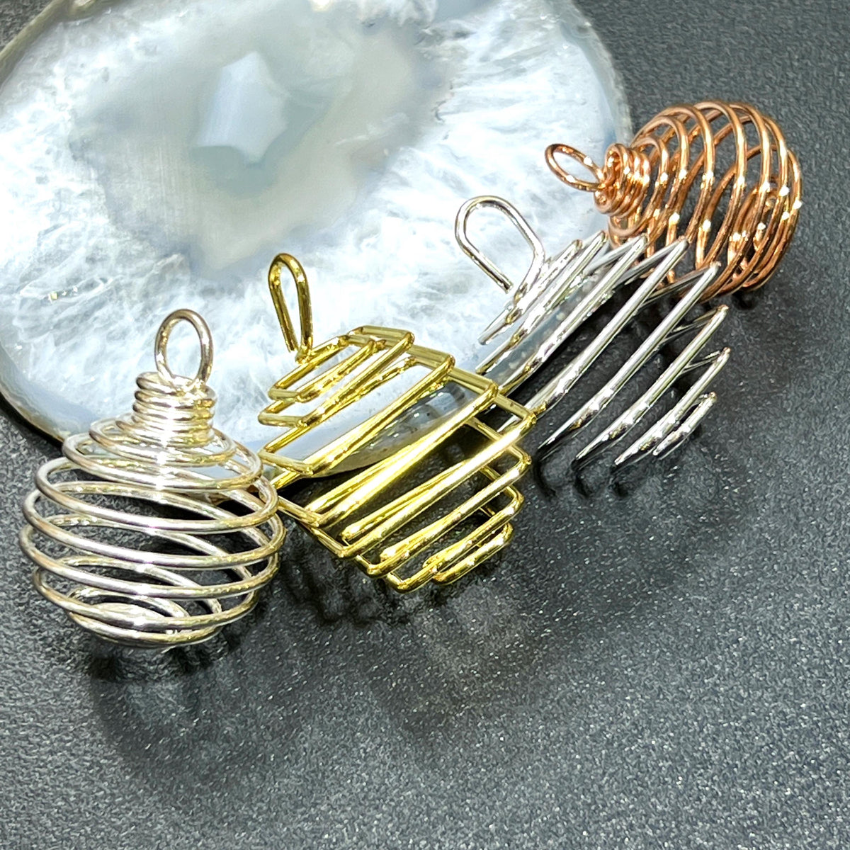 Empty spiral crystal cage pendants in silver, gold and copper finishes with sphere and square shapes