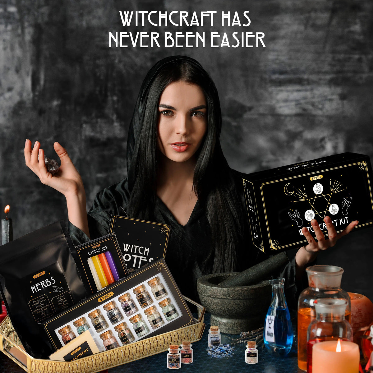 Person holding a Witchcraft kit box beside displayed crystal jars, candles, herbs, and notebook.
