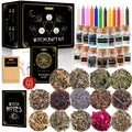 witchcraft kit with 14 crystal jars, dried herbs, colored candles, parchment, notebook, and black-and-gold box.
