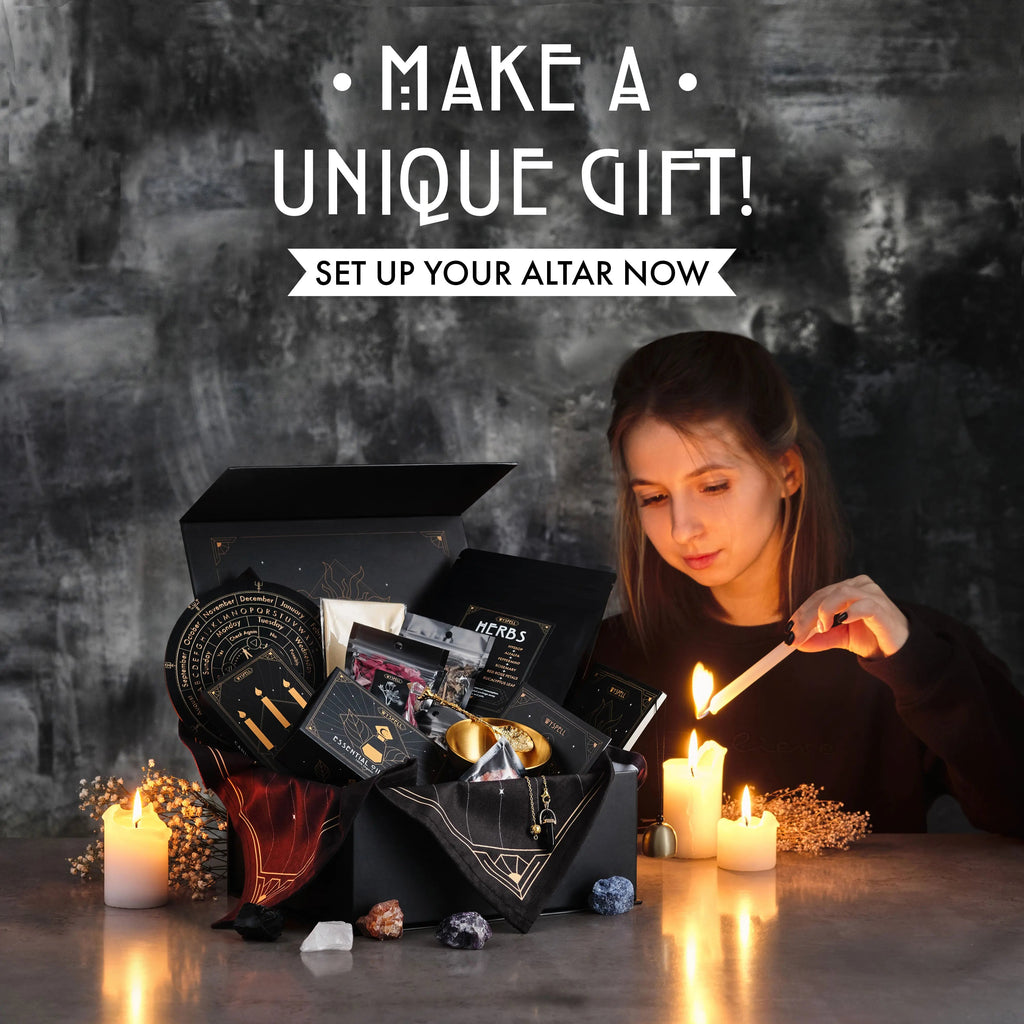 Person lighting a candle beside an open witchcraft kit box with ritual tools and natural stones.
